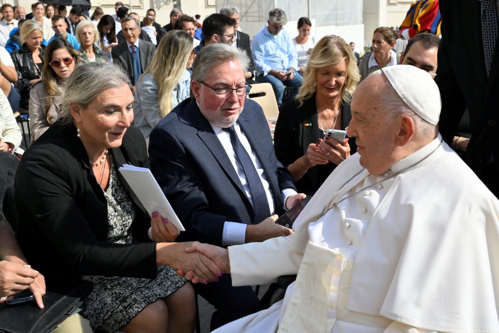 Lynn Discenza gives Pope Francis a book containing a collection of life stories written by LGBTQ+ Catholics and parents of LGBTQ+ kids from her parish, St. Patrick-St. Anthony in Hartford, Connecticut, during her meeting at St. Peter's Square at the Vatican on Sept. 18. (Vatican Media) Lynn Discenza gives Pope Francis a book containing a collection of life stories written by LGBTQ+ Catholics and parents of LGBTQ+ kids from her parish, St. Patrick-St. Anthony in Hartford, Connecticut, during her meeting at St. Peter's Square at the Vatican on Sept. 18. (Vatican Media)